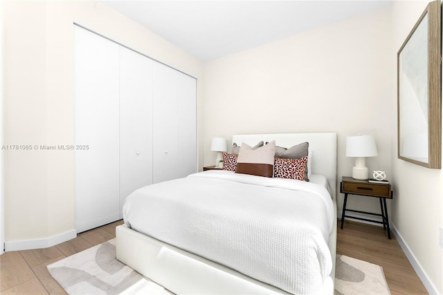 2501 SW 27th St Unit 4, Miami, FL 33133 - bedroom with baseboards, a closet, and light wood-type flooring