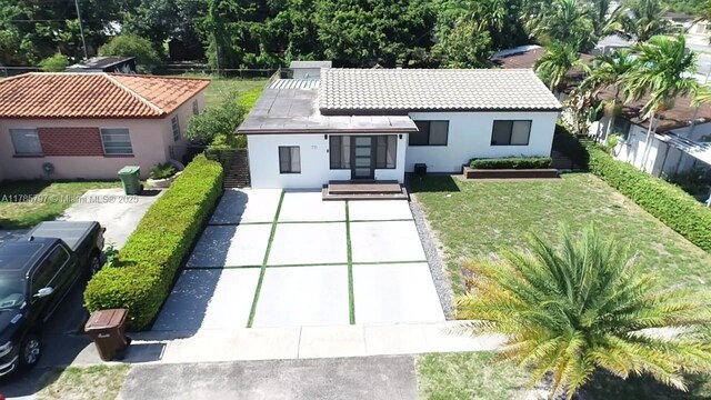 771 E 35th St, Hialeah, FL 33013 - rear view of property with stucco siding and a tile roof