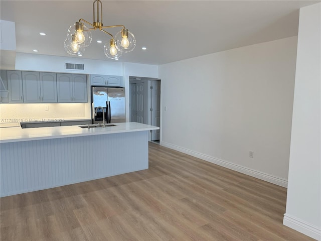 16528 Bridge End Rd, Miami Lakes, FL 33014 - kitchen featuring light countertops, visible vents, a sink, light wood-type flooring, and stainless steel fridge