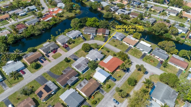 bird's eye view featuring a water view and a residential view