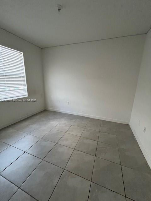 12121 NW 23rd Ct Unit 12121, Miami, FL 33167 - unfurnished room featuring light tile patterned flooring and baseboards