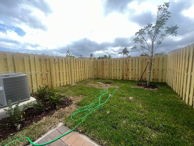 view of yard with a fenced backyard and cooling unit