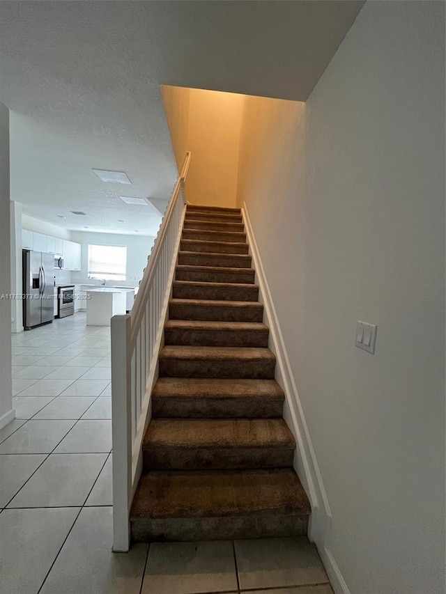 12121 NW 23rd Ct Unit 12121, Miami, FL 33167 - stairs featuring tile patterned floors and baseboards