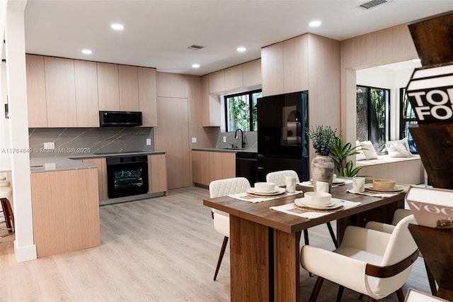 751 NE 80th St, Miami, FL 33138 - kitchen with modern cabinets, black appliances, beverage cooler, and a sink
