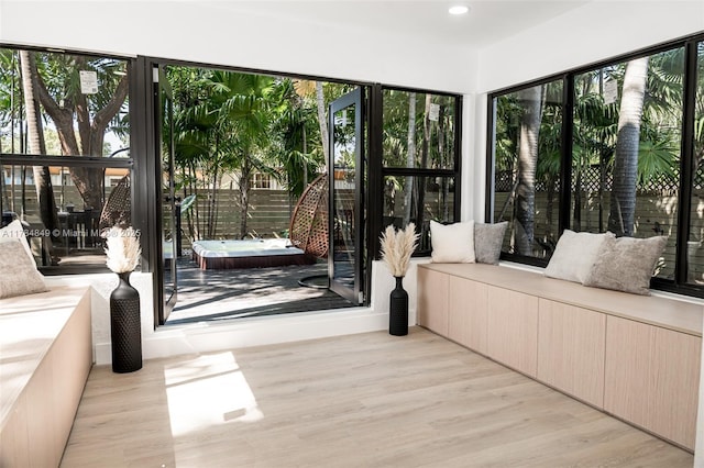 751 NE 80th St, Miami, FL 33138 - unfurnished sunroom featuring wood finished floors, a hot tub, a deck, and a healthy amount of sunlight