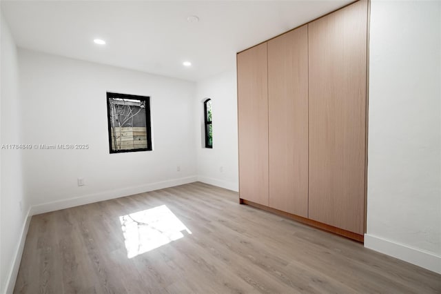 751 NE 80th St, Miami, FL 33138 - unfurnished bedroom with light wood finished floors, baseboards, recessed lighting, and a closet