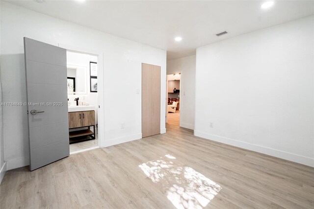 751 NE 80th St, Miami, FL 33138 - unfurnished bedroom featuring a sink, light wood-style flooring, baseboards, visible vents, and recessed lighting