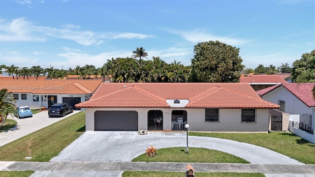 mediterranean / spanish-style house with a tiled roof, a front lawn, and curved driveway