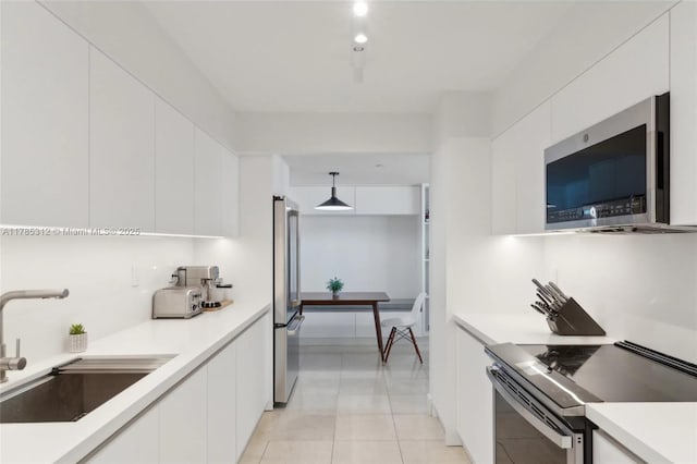 20191 E Country Club Dr Unit Ts3, Aventura, FL 33180 - kitchen featuring appliances with stainless steel finishes, a sink, white cabinetry, and light countertops