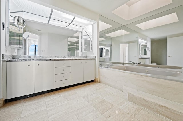 20191 E Country Club Dr Unit Ts3, Aventura, FL 33180 - bathroom with a bath, double vanity, a skylight, and toilet