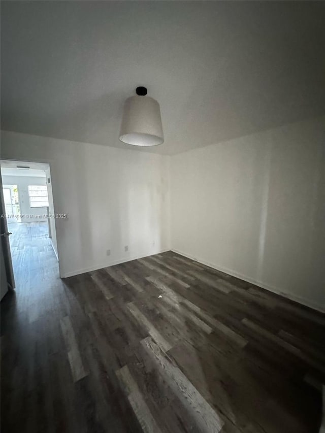 22 Suffolk A 22, Boca Raton, FL 33434 - empty room with dark wood-style floors and baseboards
