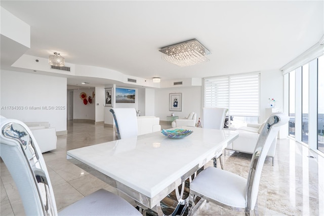 dining area featuring marble finish floor and visible vents