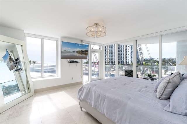 18911 Collins Ave Unit 405, Sunny Isles Beach, FL 33160 - bedroom featuring a chandelier and light tile patterned floors