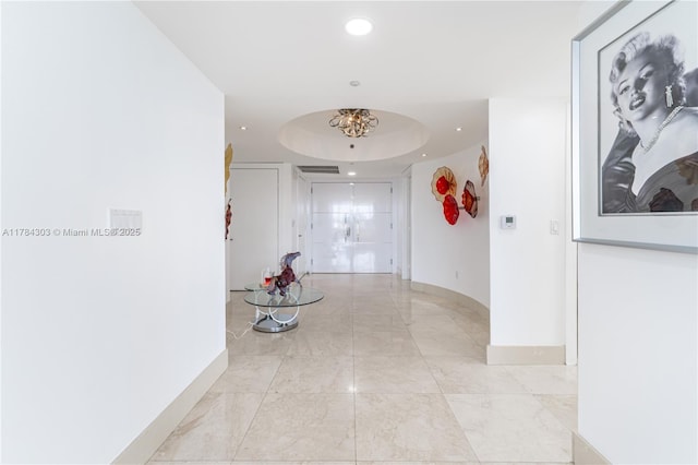 hallway with marble finish floor, baseboards, and recessed lighting