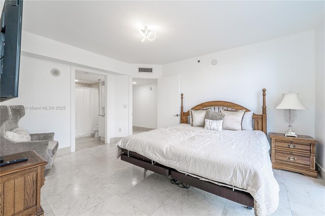 bedroom featuring visible vents, marble finish floor, and ensuite bathroom