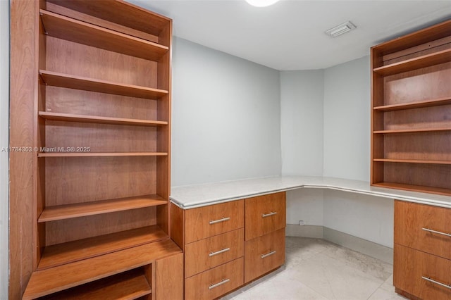 unfurnished office featuring visible vents and light tile patterned floors