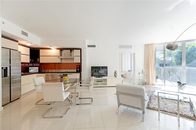 living area featuring visible vents and light tile patterned floors