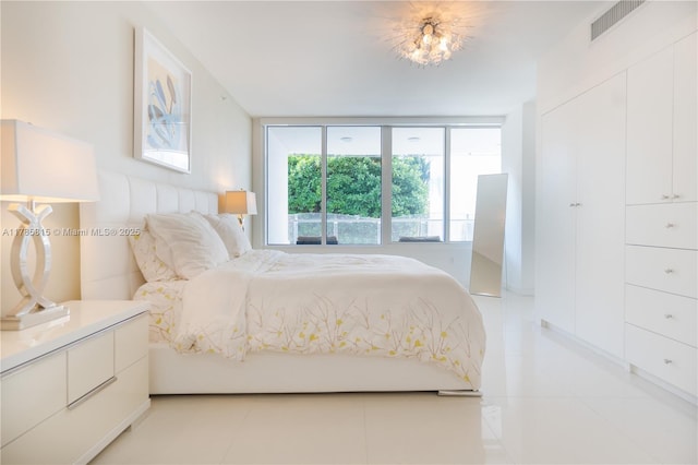 bedroom with visible vents and light tile patterned floors