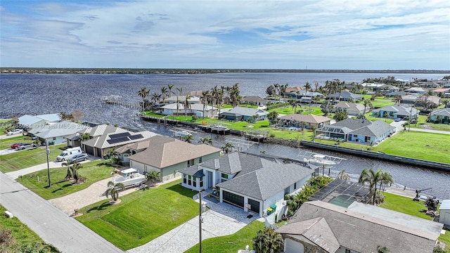 drone / aerial view with a residential view and a water view