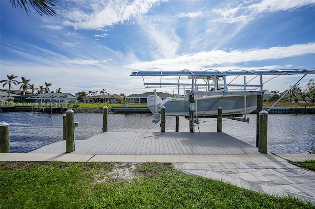 dock area with boat lift and a water view