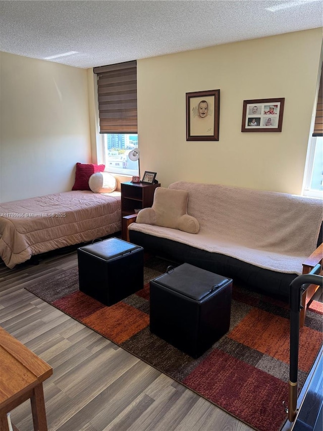 bedroom with wood finished floors and a textured ceiling