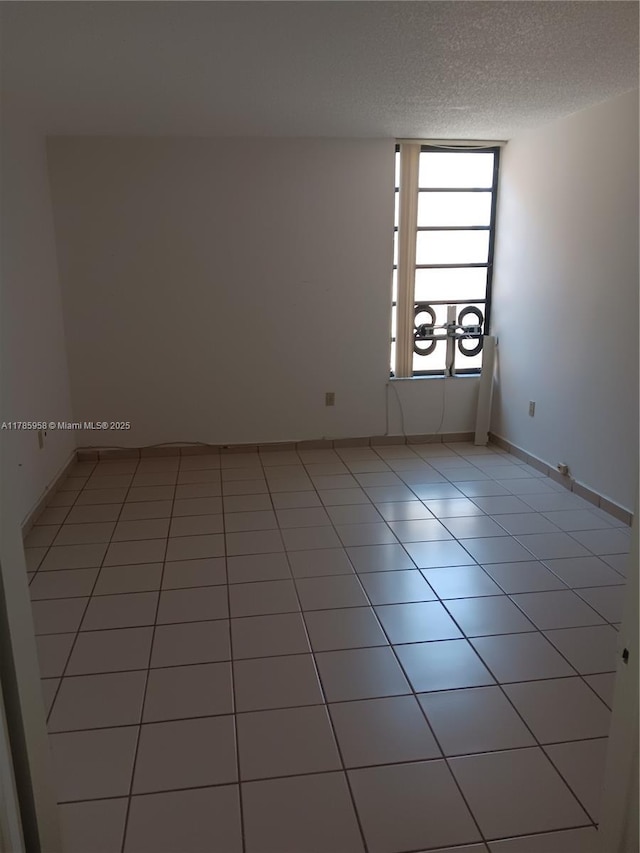 9688 Fontainebleau Blvd Unit 401, Miami, FL 33172 - unfurnished room with light tile patterned flooring and a textured ceiling