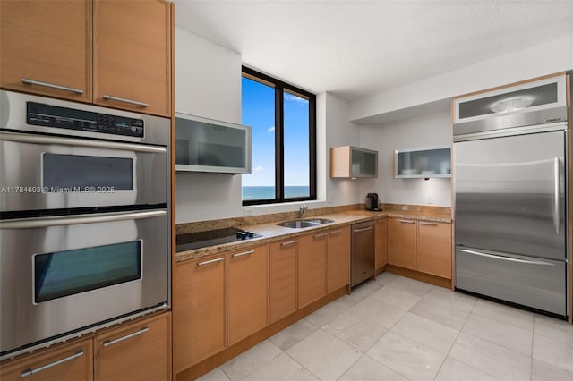 16275 Collins Ave Unit 2202, Sunny Isles Beach, FL 33160 - kitchen featuring appliances with stainless steel finishes, a sink, light tile patterned flooring, and light stone countertops