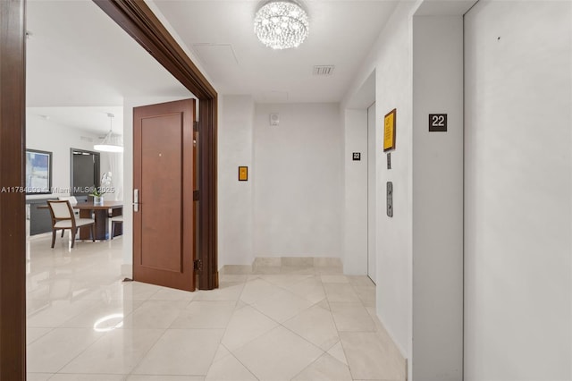 16275 Collins Ave Unit 2202, Sunny Isles Beach, FL 33160 - hall featuring elevator, a chandelier, light tile patterned floors, and baseboards