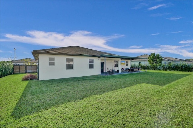 29074 SW 168th Ct, Homestead, FL 33030 - back of property with stucco siding, a yard, a patio area, and a fenced backyard