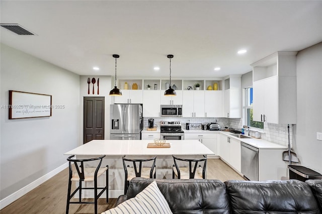 29074 SW 168th Ct, Homestead, FL 33030 - kitchen featuring stainless steel appliances, a center island, a sink, visible vents, and backsplash