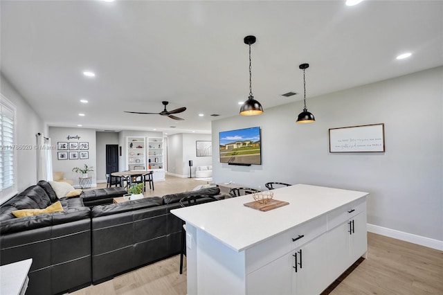29074 SW 168th Ct, Homestead, FL 33030 - kitchen featuring a center island, white cabinetry, ceiling fan, light countertops, and hanging light fixtures