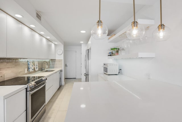 kitchen featuring recessed lighting, decorative backsplash, appliances with stainless steel finishes, and white cabinets
