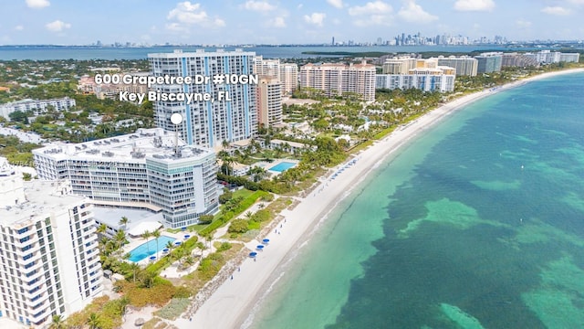 bird's eye view featuring a water view, a city view, and a view of the beach