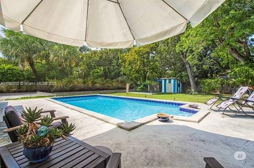 outdoor pool with a patio area