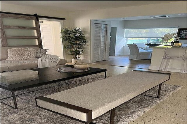 827 NE 140th St, North Miami, FL 33161 - living area featuring a barn door