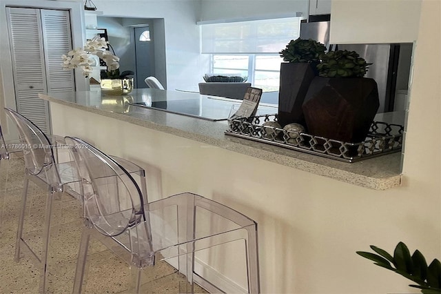 827 NE 140th St, North Miami, FL 33161 - kitchen featuring speckled floor and black electric cooktop