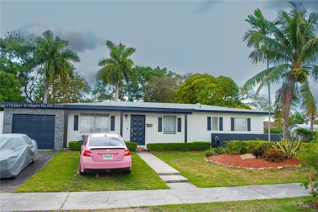 single story home with stucco siding, a front lawn, and a garage