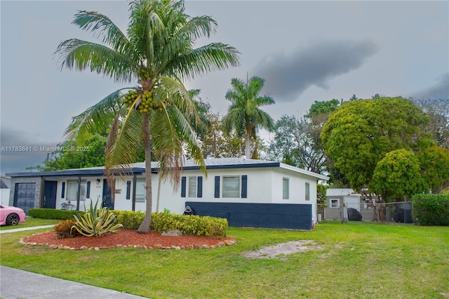 view of property exterior with fence, a yard, and stucco siding