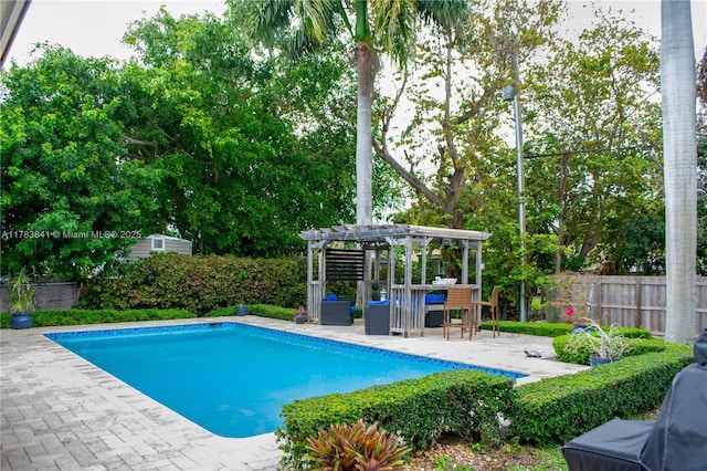 view of swimming pool with a pergola, a fenced in pool, a patio, and fence