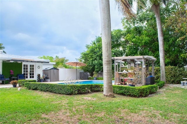 view of yard with a fenced in pool, french doors, and fence
