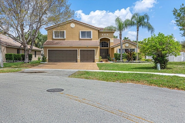 13063 NW 11th Ct, Sunrise, FL 33323 - mediterranean / spanish house with an attached garage, a tile roof, stucco siding, a front lawn, and driveway