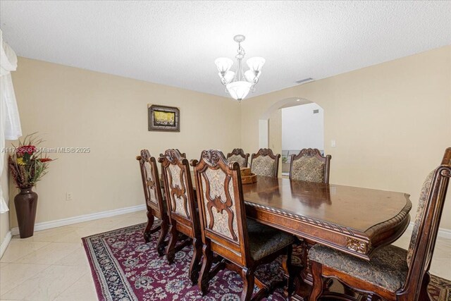 13063 NW 11th Ct, Sunrise, FL 33323 - dining space featuring arched walkways, a chandelier, and baseboards