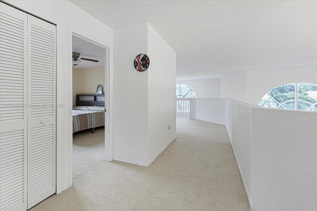 13063 NW 11th Ct, Sunrise, FL 33323 - corridor with carpet, a textured ceiling, an upstairs landing, and baseboards