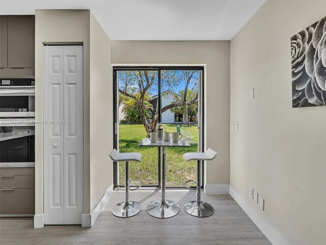 dining room featuring baseboards and wood finished floors