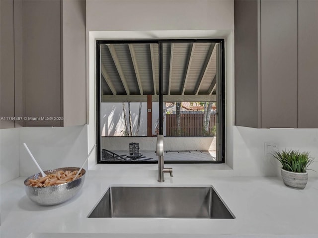 kitchen with a sink, modern cabinets, and light countertops