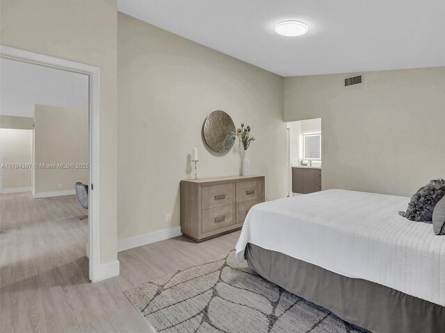 bedroom featuring baseboards, visible vents, and light wood-style flooring