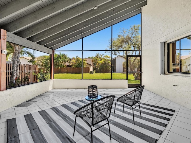 unfurnished sunroom with beam ceiling