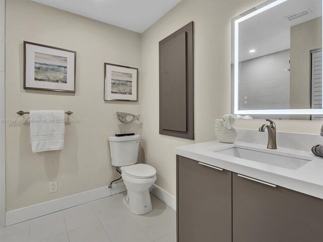 bathroom with tile patterned flooring, vanity, toilet, baseboards, and visible vents