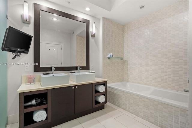 bathroom with tile patterned flooring, a sink, a relaxing tiled tub, and double vanity