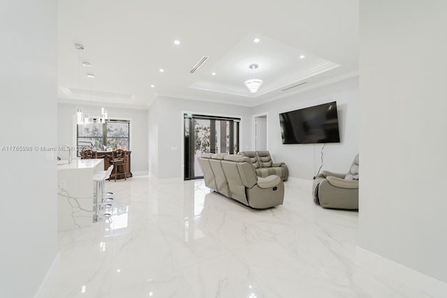 398 35th Ave NW, Naples, FL 34120 - living area featuring a tray ceiling, baseboards, crown molding, and marble finish floor